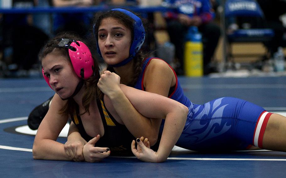 Sophia Seaburgh and Camille Acosta wrestle on the mat.