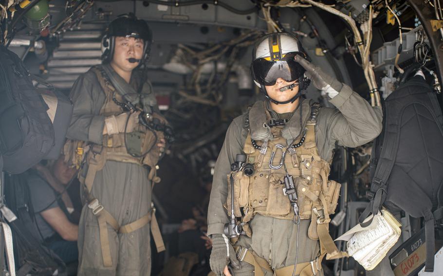 Sgt. Hunter Clark signals ready for takeoff from the amphibious assault ship USS Boxer during a humanitarian mission in the East China Sea. 