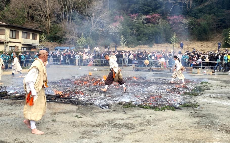 Monks walk across hot coals.