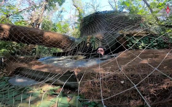 In this photo taken from video released by the Russian Defense Ministry on Sunday, Aug. 11, 2024, a Russian Army tank covered with camouflage net takes a position at an area of ​​Kursk region of Russia. (Russian Defense Ministry Press Service via AP)