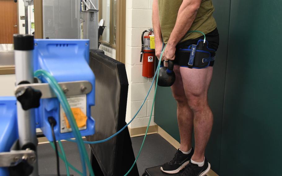 A solider shown from the chest down training.