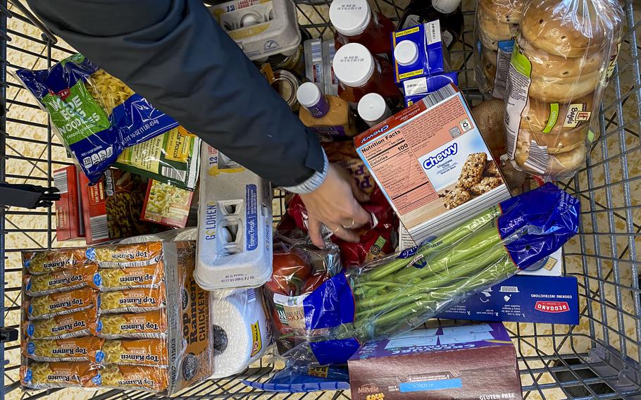 A woman in Binghamton, N.Y., calculates the exact cost of her groceries so she can make sure to stay within her monthly budget. 