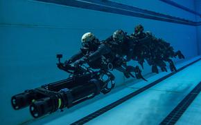 SEAL team members use a propulsion vehicle during an exercise in Virginia Beach, Va., July 1,2024.