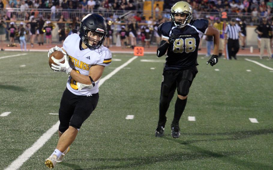 ASIJ running back tries to gain yards against Humphreys.