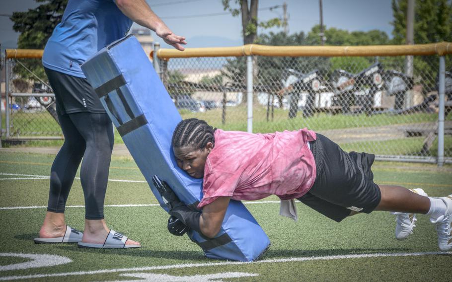 Zavier Jones, an 11th grade student of Osan Middle High School, performs a drill during football practice at Osan Air Base, South Korea, Monday, Aug. 5, 2024.