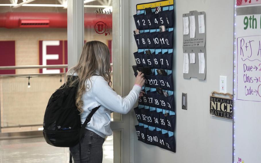 A student in Delta, Utah, places her cellphone phone holder at Delta High School