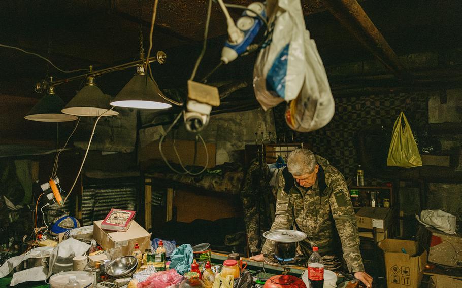 A Ukrainian soldier who goes by Yura makes coffee in a bunker in the Avdiivka plant.