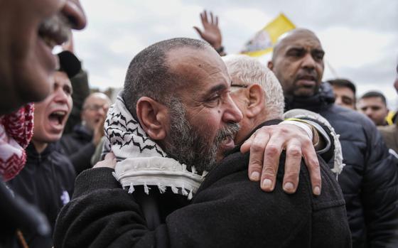 Palestinian prisoners are greeted as they exit a Red Cross bus after being released from Israeli prison following a ceasefire agreement between Israel and Hamas, in the West Bank city of Ramallah, Saturday Feb. 8, 2025. (AP Photo/Mahmoud Illean)