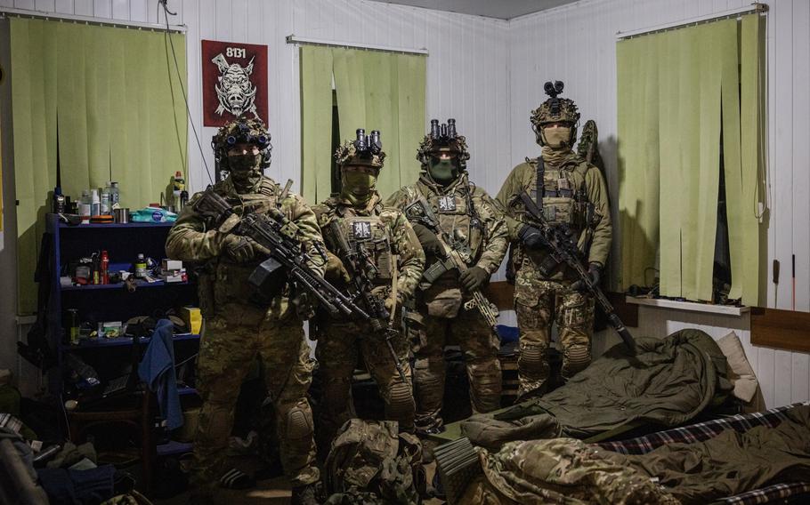 A quartet of uniformed Ukraine soldiers.