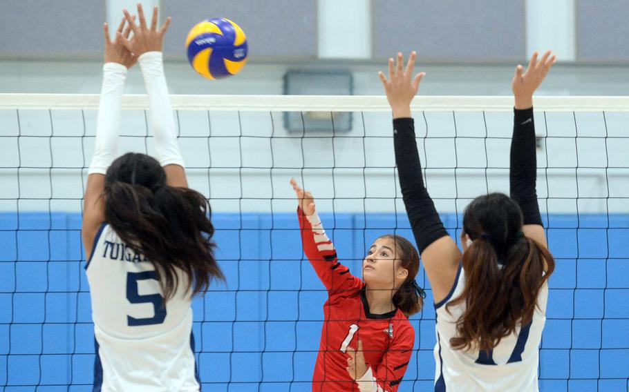 E.J. King and Osan play girls volleyball.