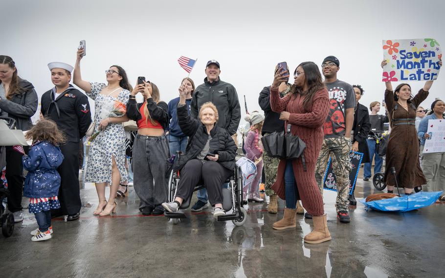 Friends and family wait for the USS O’Kane to pull into its homeport