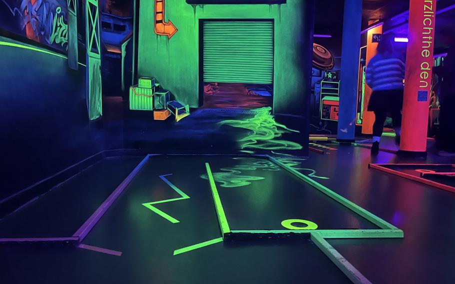 A miniature golf hole with 3D paint and obstacles.