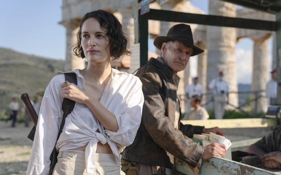 Phoebe Waller-Bridge, left, and Harrison Ford co-star in “Indiana Jones and the Dial of Destiny.” 