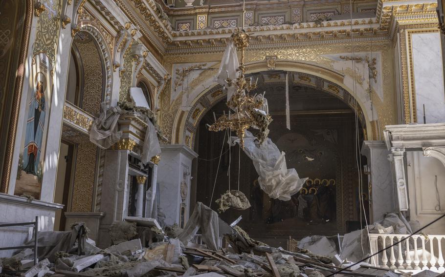 Debris falls from the ceiling as workers work to clean the Transfiguration Cathedral. 