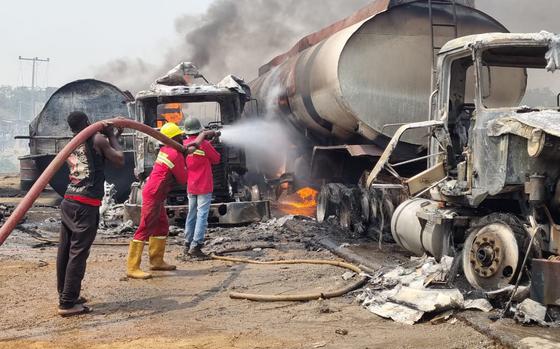 Firefighters extinguish fire from a tanker that exploded in Suleja, Nigeria, Saturday, Jan. 18, 2025. (AP Photo/Arise News)