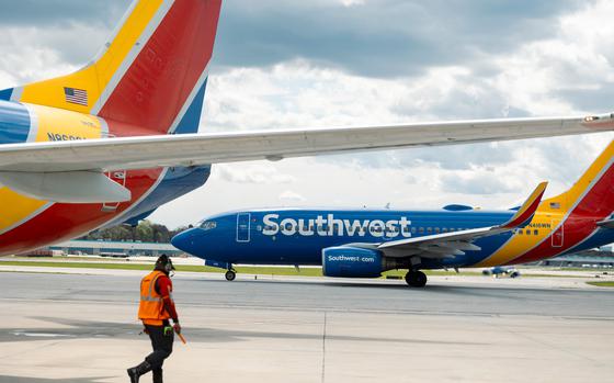 A ramp agent walks past a Southwest Airlines Boeing 737-700 airplane in Baltimore. 