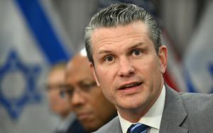 Secretary of Defense Pete Hegseth speaks at meeting with an Israeli flag in the background.