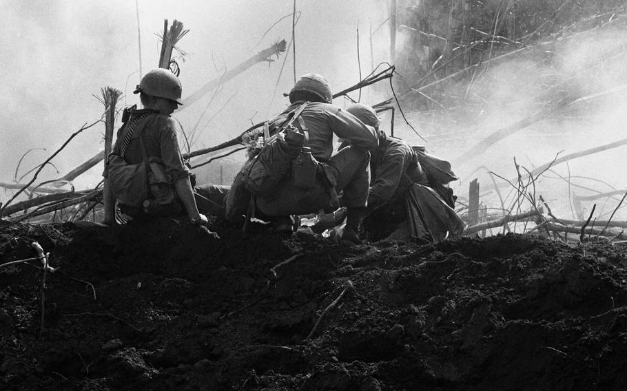 U.S. troops bandage a wounded infantryman in Vietnam in 1966.