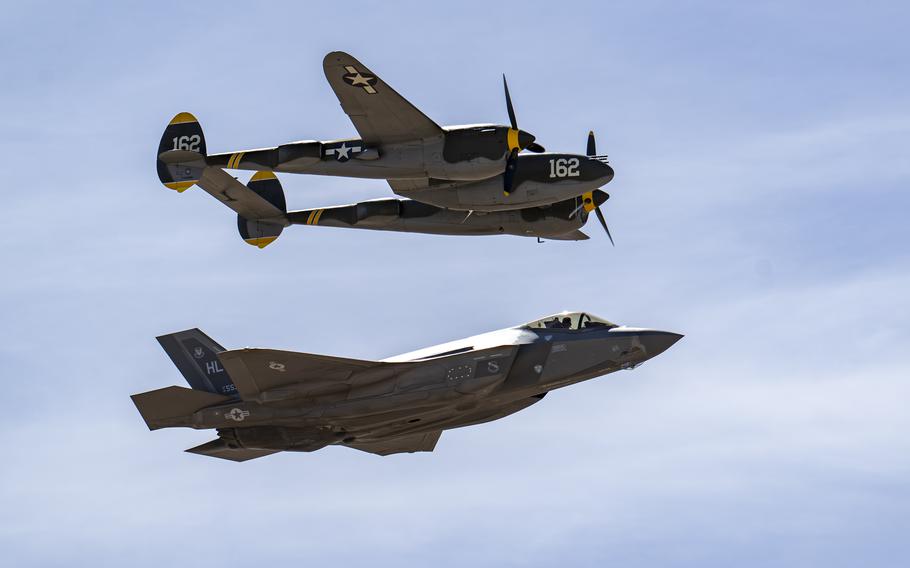 The two aircraft from different eras fly together.