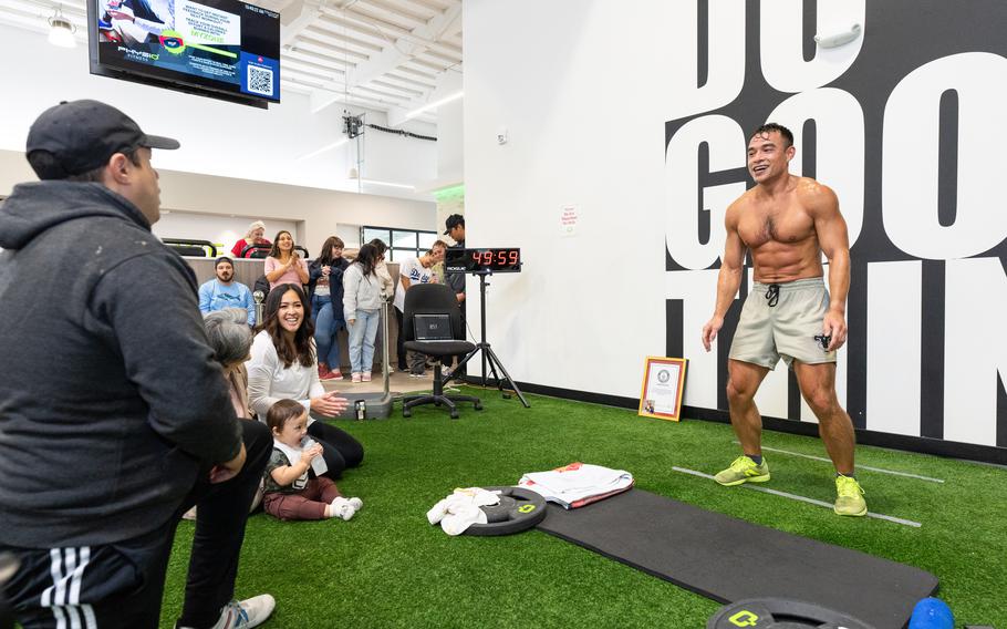 A U.S. soldier smiles as he nears his goal of chest-to-ground burpees.