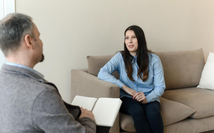 A young woman talks  to a man psychologist. 