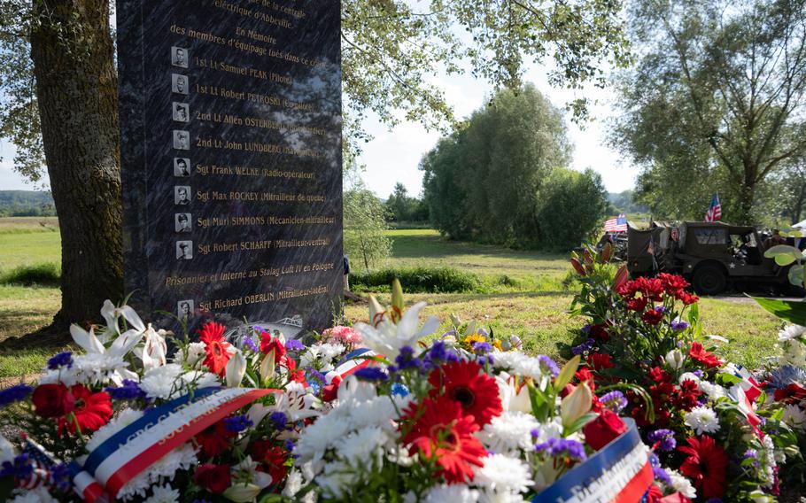 A memorial for the Spare Charlie B-17 bomber crew includes the names and photos of each crew member. 