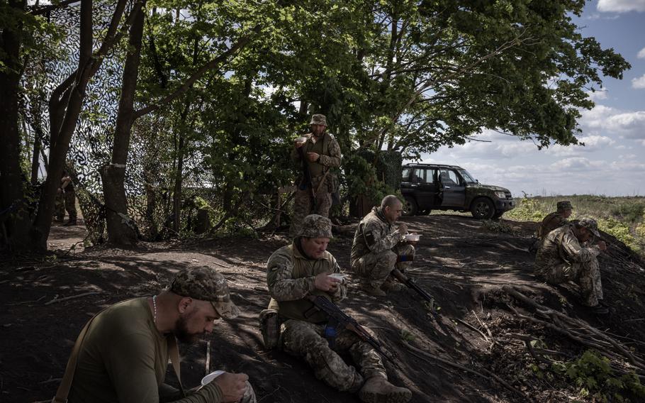 Ukrainian soldiers eat lunch during a break in training. 