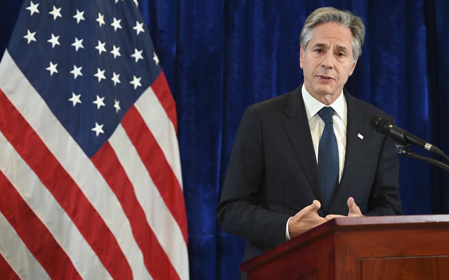 Antony Blinken speaks at a podium in front of a U.S. flag.