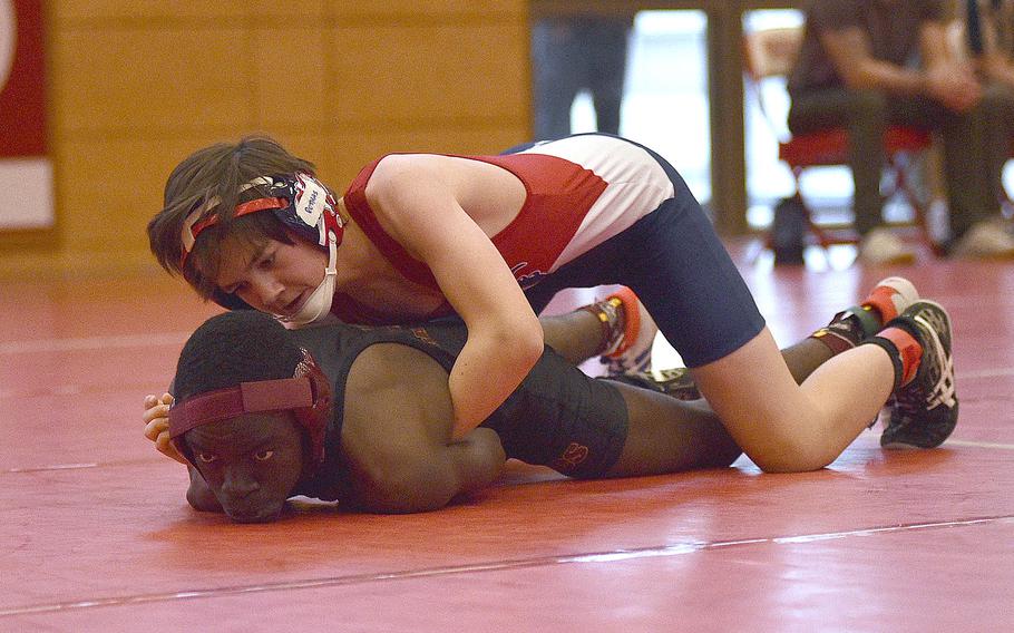 Lakenheath's Micah Rothas keeps Baumholder's Jason Danso from moving during a 120-pound match at a wrestling meet on Dec. 9, 2023, at Kaiserslautern High School in Kaiserslautern, Germany.