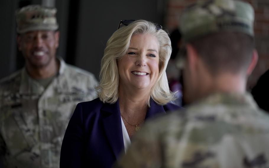 Christine Wormuth smiles as she talks to a soldier.