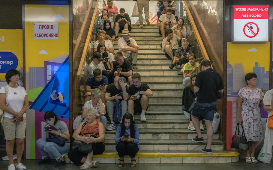 People take shelter in the Teatralna metro station during a Russian air attack, in Kyiv, on Aug. 26, 2024, amid the Russian invasion of Ukraine. 