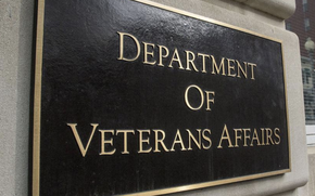 A brown sign with gold letters reading “Department of Veterans Affairs” on the side of the agency’s headquarters building.