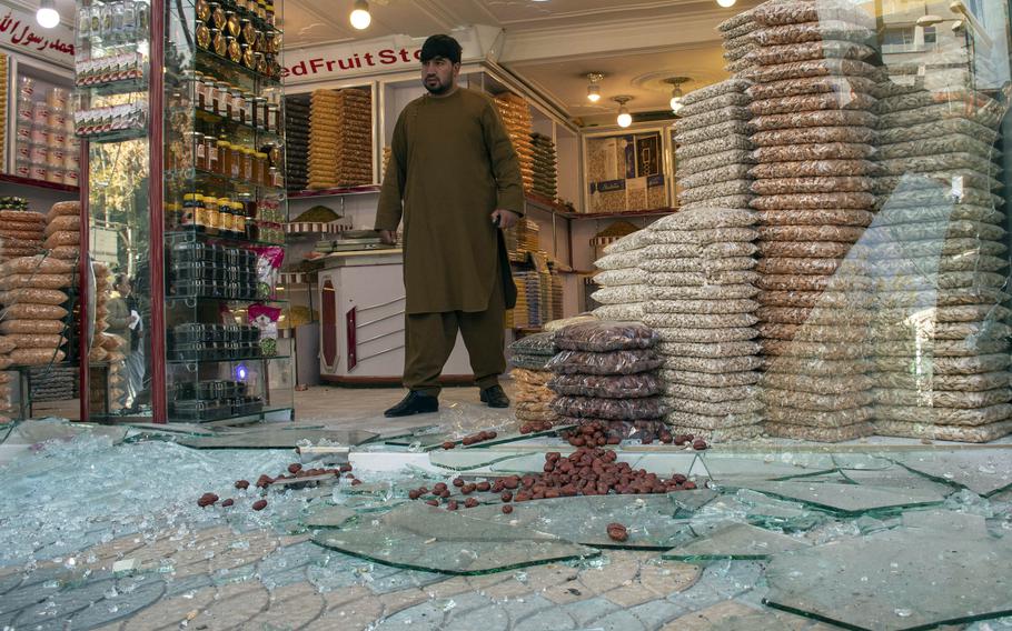 A man exits a shop damaged by rocket fire in Kabul, Afghanistan, in November 2020. The number of deaths and casualties in the country is going up at a record pace this year, the United Nations said July 26, 2021.