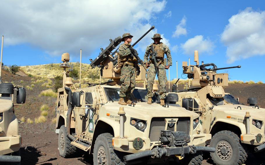 Marines stand atop one of a pair of vehicles that carry a Marine Air Defense Integrated System during live-fire training at Pohakuloa Training Area, Hawaii, Jan. 25, 2025.