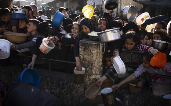 FILE - Palestinians line up for a free meal in Rafah, Gaza Strip, on March 12, 2024. (AP Photo/Fatima Shbair, File)