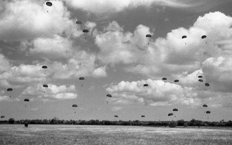 Parachutes glide toward earth as some 550 paratroopers reenacted the 101st Airborne Division D-Day jump, June 5, 1994, in honor of D-Day’s 50th anniversary.