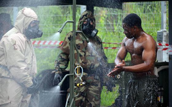 A U.S. Marine, left, who specializes in chemical, biological ...