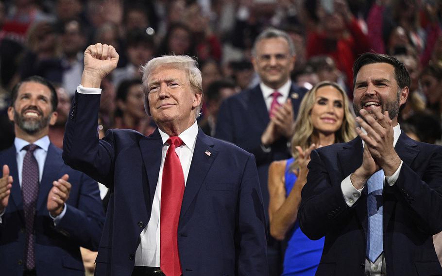 Former President and Republican presidential candidate Donald Trump gestures next to Republican vice-president candidate Sen. J. D. Vance during the first day of the 2024 Republican National Convention in Milwaukee, on July 15.