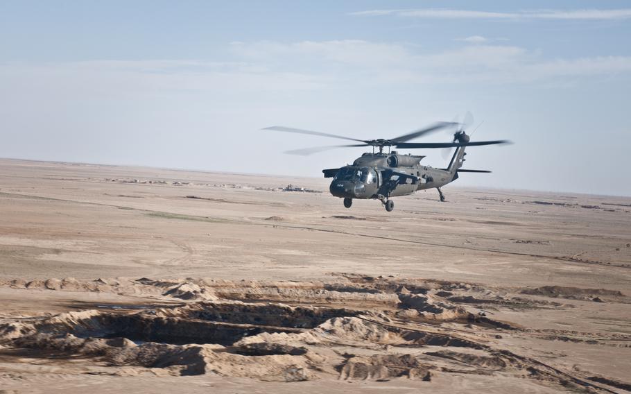 A U.S. UH-60 Black Hawk helicopter flies over the Syrian landscape, March 12, 2018. U.S. troops captured an Islamic State official and two of his associates during an evening helicopter raid Saturday, April 8, 2023, in eastern Syria, U.S. Central Command announced