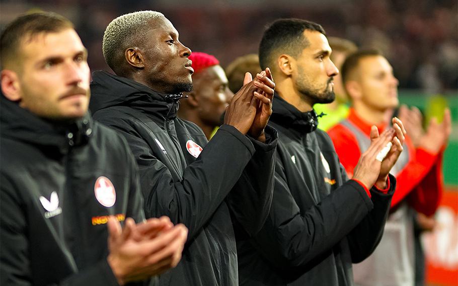 Kaiserslautern players stand in line to applaud their fans.