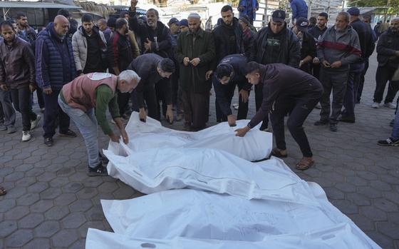 Bodies of victims of an Israeli airstrike at the Nuseirat refugee camp are prepared for the funeral prayer outside the Al-Aqsa Martyrs hospital in Deir al-Balah, Gaza Strip, Saturday, Dec. 21, 2024. (AP Photo/Abdel Kareem Hana)