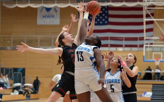 AFNORTH's Hadley Keeton and Hohenfels' Jillian Odhiambo fight for a rebound in the Division III girls final at the DODEA-Europe basketball championships in Wiesbaden, Germany, Feb. 15, 2025. AFNORTH took the title with a 47-34 win.