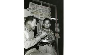 HED: Tasty cake, 1960

Seoul, South Korea, October 1960: Yong Kun (Tex) Kim enjoys a piece of cake at the USO in Seoul. Found wandering the streets alone, the 8-year-old orphaned boy has been cared for by personnel of the USO Seoul. 

Stars and Stripes’ Pacific archives house many images of South Korean children affected by the Korean War. Many are of orphans living in homes founded and/or funded by either U.S. servicemembers or the United Nations. Also found in our archives are images of so-called “Unit Mascots,” children orphaned by the war who were “adopted” by U.S. military units. The children would live on base or in camp with the unit and were often outfitted in smaller versions of the unit’s uniform. Unfortunately, we know little to nothing of what happened to them.

Looking for Stars and Stripes’ historic coverage, including that on so-called "Unit Mascots"? Subscribe to Stars and Stripes’ historic newspaper archive. We have digitized our 1948-1999 European and Pacific editions, as well as several of our WWII editions and made them available online through https://starsandstripes.newspaperarchive.com/

META TAGS: USO; United Services Organization; Korean; orphan; orphaned children; Korean war; unit mascot