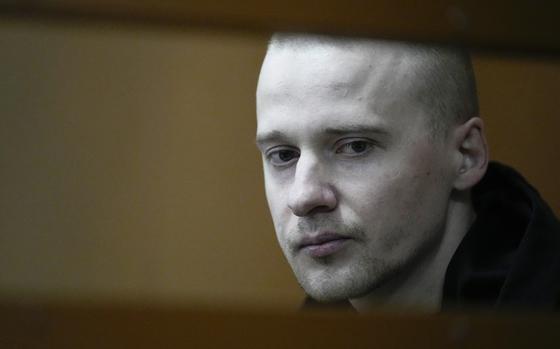 Alexander Permyakov, a Ukrainian national standing trial over a car bombing that injured well-known nationalist novelist and ardent Kremlin supporter Zakhar Prilepin, sits in a glass cage in a courtroom prior to a session in the Russian Military Court in Moscow, Russia, Monday, Sept. 30, 2024. (AP Photo/Alexander Zemlianichenko)