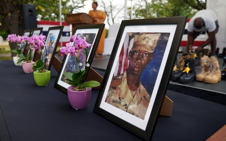 Photos of deceased sailors are displayed during the Bells Across America ceremony at Yokosuka Naval Base, Japan, Thursday, Sept. 19, 2024.