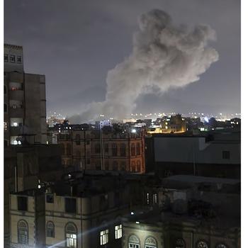 Smoke rises above buildings