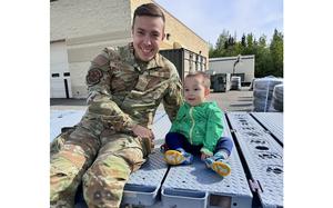 James Mixsooke and his son smile as they pose.