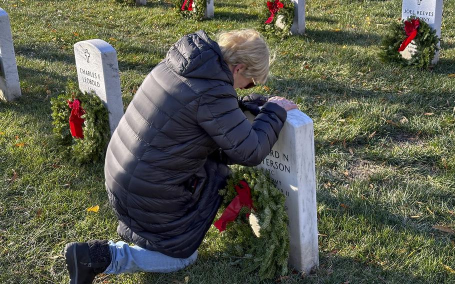 Charlotte Patterson is overcome with emotion after placing a wreath at the grave of her husband, Edward N. Patterson, during Wreaths Across America at Arlington National Cemetery, Dec. 14, 2024. Edward Patterson was a POW during World War II, earning a Silver Star and a Purple Heart, and worked for the CIA after his military days.