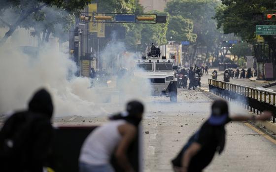 FILE - Protesters clash with police during demonstrations against the official election results declaring President Nicolas Maduro's reelection, the day after the vote in Caracas, Venezuela, July 29, 2024. (AP Photo/Matias Delacroix, File)