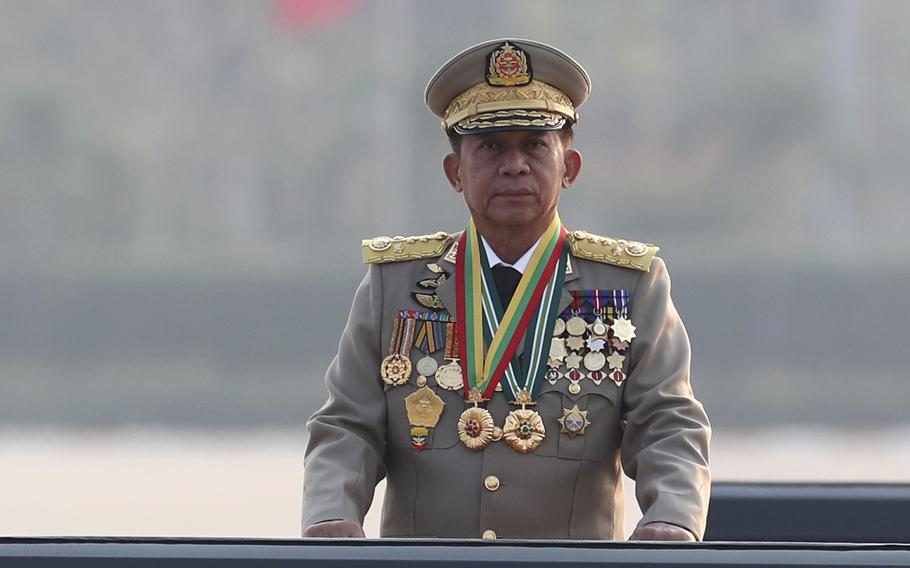 The leading figure of Myanmar’s ruling junta inspects officers during a military parade. He is the sole person in the photo.